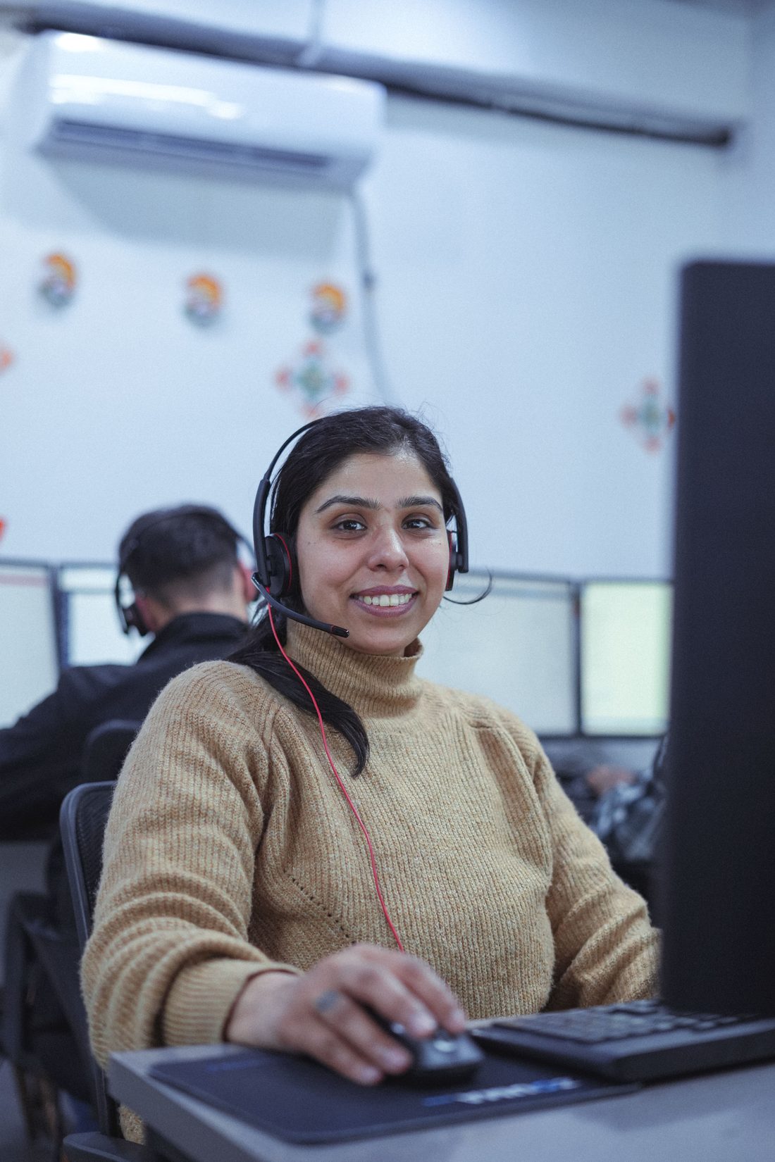 Dedicated offshore team members working UK business hours at individual workstations